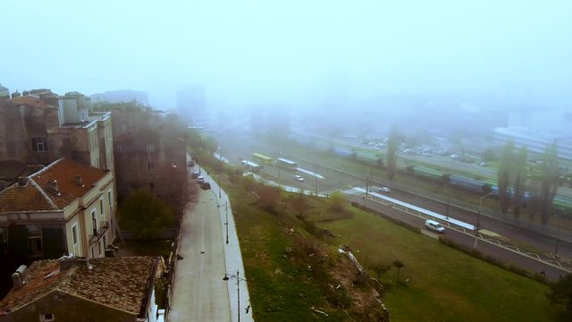Aerial drone left right shot and down up shot of Constanta's Old town and port, ending inside the fog