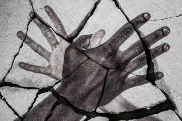 African american and caucasian hands connected against a broken system