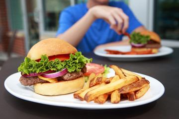 Hamburger and french fries meal at an outdoor cafe