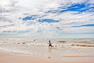 Fototapeta na wymiar Boy running on beach