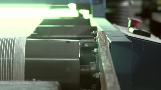 Close-up Of An Industrial Dryer Conveyor Is Spinning In A Print Shop