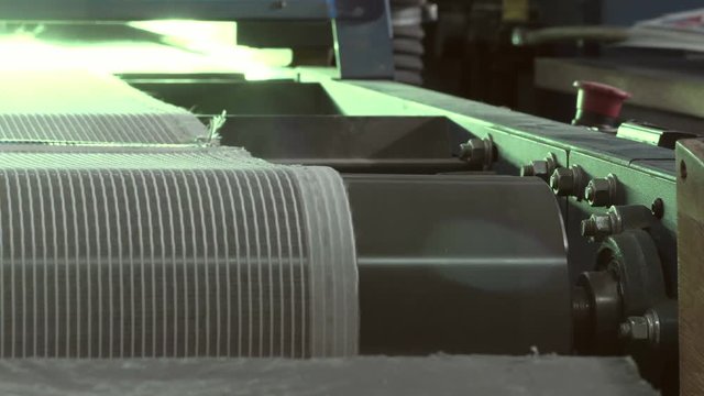 Close-up Of An Industrial Dryer Conveyor Is Spinning In A Print Shop