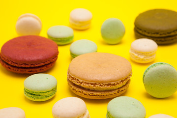 Fototapeta na wymiar Luxury french macaroons dessert over yellow background