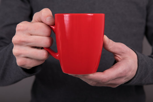 A Man Holding Red Mug