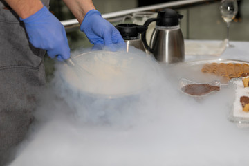 Fascinating process of preparation of ice cream with use of dry ice in wafer cups.
