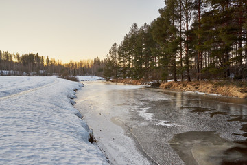 Frozen river in spring evening