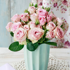 Bouquet of pink roses in ceramic vase.