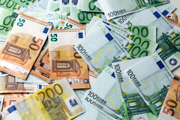 Euro banknotes from above. Scattered banknotes on the table.