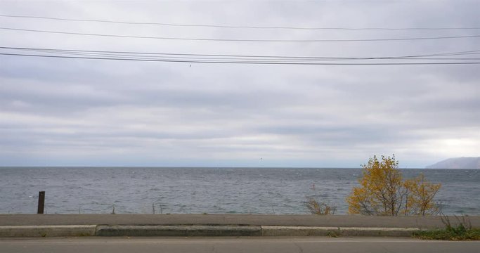 Glum cloudy sky and lake water wave landscape veiw