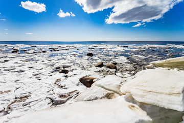 Saint-Petersburg. Shore of the Gulf of Finland in spring. Ice floes , sun and blue water of the Baltic sea.