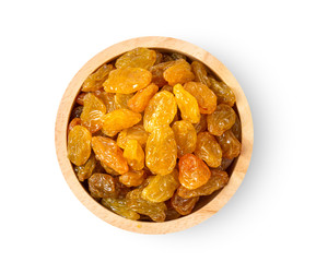 Yellow golden raisins in wood bowl isolated on white background. top view