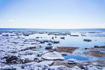 Saint-Petersburg. Shore of the Gulf of Finland in spring. Ice floes , sun and blue water of the Baltic sea.