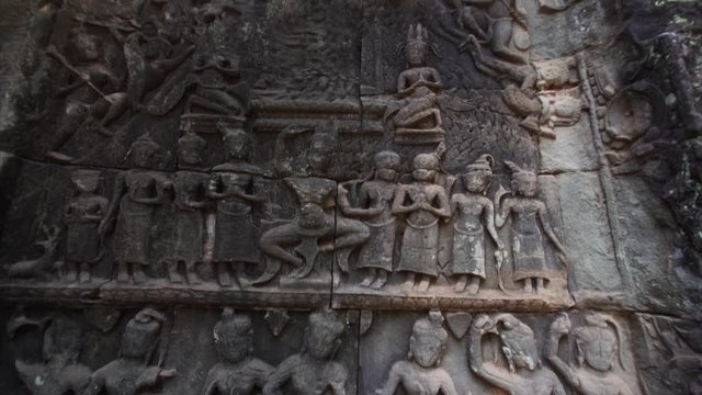 Amazing bas-reliefs of king's life and apsara, female spirit of the clouds and waters in Hindu and Buddhist culture. Ta Prohm temple, Cambodia (Angkor Wat complex)