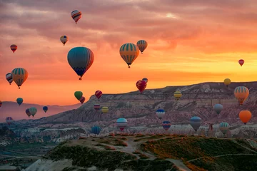 Wall murals Balloon Hot Air balloons flying tour over Mountains landscape spring sunrice Cappadocia, Goreme Open Air Museum National Park, Turkey nature background.
