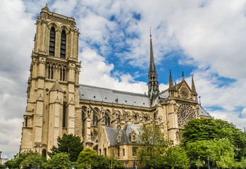 Fototapeta na wymiar The Notre Dame De Paris- Our Lady of Paris cathedral, against cloudy sky. 