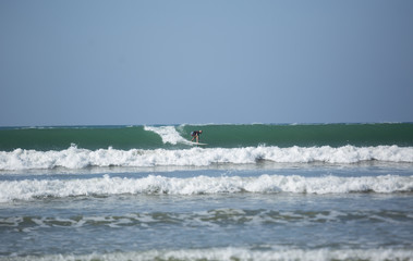 Surfer catching wave in the sea,February 23,2019