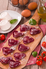 Red heart ravioli with tomato, mozzarella and basil.