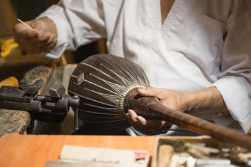 adult master restores old musical instruments. production of stringed instruments