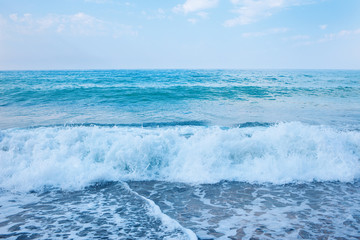 Beautiful view of splashing blue waves near the beach.