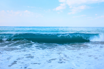 Beautiful view of splashing blue waves near the beach.