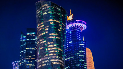 Doha Qatar skyline cityscape with skyscrapers at night