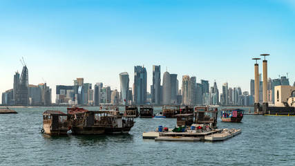 Fototapeta na wymiar Doha Qatar skyline with traditional Qatari Dhow boats in the harbor