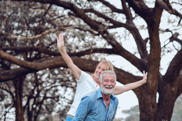 Lifestyle senior couple happy and relaxed . Good Healthy elderly in park nature. Group of Senior Retirement dancing and enjoy vacation summer 