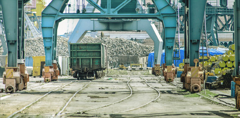 Railway wagon under loading cranes in sea port. Business and transportation. Cargo terminal -...