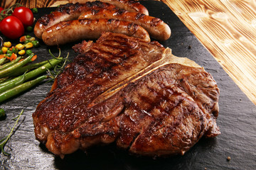 Assorted delicious grilled meat with vegetable on a barbecue with steak