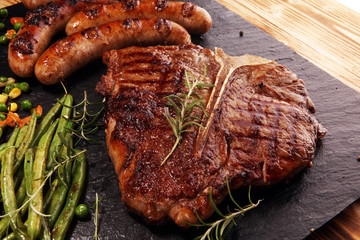 Assorted delicious grilled meat with vegetable on a barbecue with steak