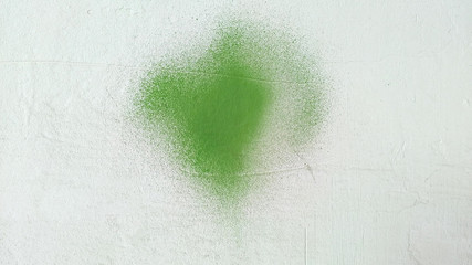 Green paint stain on grunge cement texture. Old gray concrete wall background.