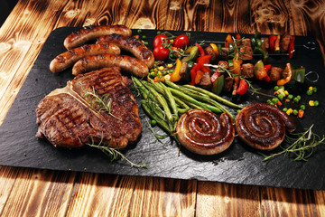 Assorted delicious grilled meat with vegetable on a barbecue with steak