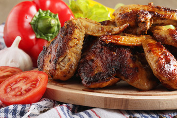 Chicken wings barbecue with different vegetables	