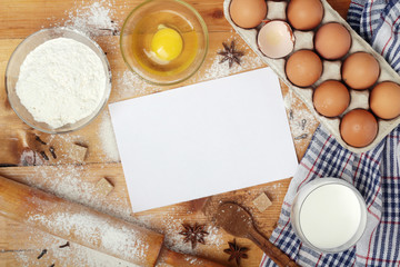 Fototapeta na wymiar Frame of food ingredients for baking with a paper sheet for a recipe 