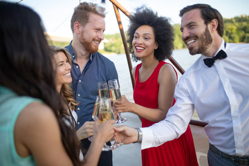 Group of happy friends drinking champagne and celebrating New Year