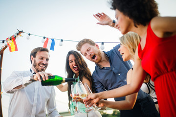 Group of happy people or friends having fun at party