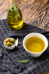 Tasty olive oil on wooden table