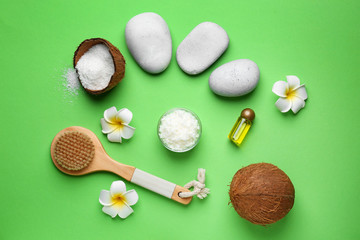 Composition with spa stones, coconut oil and brush on color background