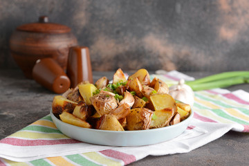 Plate with tasty baked potato on table