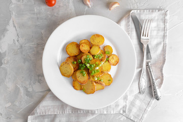 Plate with tasty baked potato on table