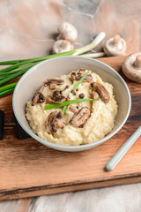 Bowl with tasty mashed potato on table