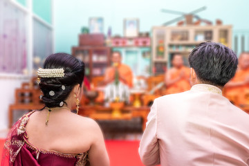 Obraz na płótnie Canvas Behind the bride and groom and monk.