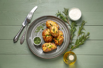 Tasty baked potato on wooden table