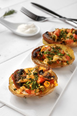 Tasty baked potato on white table