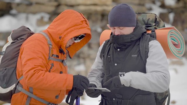 People Looking at Map While Trekking 