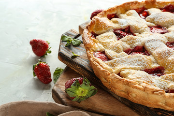 Tasty strawberry pie on table