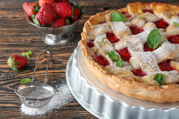 Tasty strawberry pie on wooden table