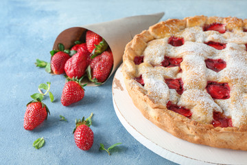Tasty strawberry pie on color background