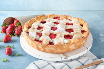 Tasty strawberry pie on color background