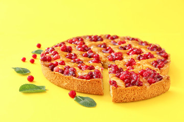 Tasty cranberry pie on color background